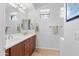Bright bathroom featuring a double sink vanity, updated lighting, and a large mirror at 34457 N Legend Trail Pkwy # 1013, Scottsdale, AZ 85262