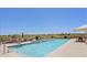 A well-maintained community pool with lounge chairs and a jacuzzi tub at 34457 N Legend Trail Pkwy # 1013, Scottsdale, AZ 85262