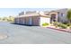 Exterior view of garage, with multiple bays, and a building with stairs and desert landscaping at 34457 N Legend Trail Pkwy # 1013, Scottsdale, AZ 85262