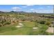 Picturesque golf course with lush green fairways and sand traps, set against a backdrop of mountains and desert landscape at 34457 N Legend Trail Pkwy # 1013, Scottsdale, AZ 85262