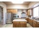 Well-equipped kitchen with stainless steel appliances, custom cabinets, and a central island at 34457 N Legend Trail Pkwy # 1013, Scottsdale, AZ 85262