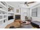 Living room featuring tile floors, a fireplace, a ceiling fan, and a comfortable seating area at 34457 N Legend Trail Pkwy # 1013, Scottsdale, AZ 85262