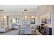This is a living room with a TV, shelves, paintings, a table, chairs and other nice interior design elements at 34457 N Legend Trail Pkwy # 1013, Scottsdale, AZ 85262