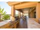 Covered outdoor grill and dining area with views of the desert landscape offers a perfect space for entertaining guests at 34457 N Legend Trail Pkwy # 1013, Scottsdale, AZ 85262
