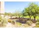 Expansive yard with desert landscaping and distant golf course views at 34457 N Legend Trail Pkwy # 1013, Scottsdale, AZ 85262