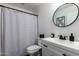 Modern bathroom with stylish round mirror, black hardware, and patterned shower curtain at 34463 N Karan Swiss Cir, San Tan Valley, AZ 85143