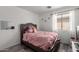 Charming bedroom with a plush bed, soft textures, and a decorative wall mirror at 34463 N Karan Swiss Cir, San Tan Valley, AZ 85143