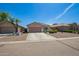 Charming single-story home featuring a well-maintained lawn, a spacious two-car garage, and neat landscaping at 34463 N Karan Swiss Cir, San Tan Valley, AZ 85143