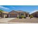 Lovely single-story home featuring a well-manicured gravel yard, a two-car garage, and charming curb appeal at 34463 N Karan Swiss Cir, San Tan Valley, AZ 85143