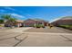 Inviting single-story home with a low-maintenance gravel yard, an attached two-car garage, and a welcoming entrance at 34463 N Karan Swiss Cir, San Tan Valley, AZ 85143