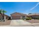 Inviting single-story home with a well-maintained gravel yard, an attached two-car garage, and a welcoming entrance at 34463 N Karan Swiss Cir, San Tan Valley, AZ 85143
