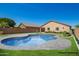 An inground pool highlights the backyard of this home with an impeccable lawn and pristine design at 34463 N Karan Swiss Cir, San Tan Valley, AZ 85143