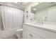 Well-lit bathroom featuring a neutral vanity, quartz countertops, and a shower with white tiling at 3730 W Michigan Ave, Glendale, AZ 85308