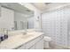 Bright bathroom featuring a neutral vanity, solid surface countertops, and a blue shower curtain at 3730 W Michigan Ave, Glendale, AZ 85308