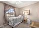 Cozy bedroom with neutral walls, a ceiling fan, and a window; ideal for relaxation at 3730 W Michigan Ave, Glendale, AZ 85308