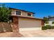 Charming home showcasing a two car garage, brick accents, and well maintained landscaping at 3730 W Michigan Ave, Glendale, AZ 85308