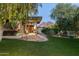 Expansive backyard featuring a covered patio, mature trees, and picturesque mountain views at 3901 E San Miguel Ave, Paradise Valley, AZ 85253