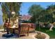Charming backyard patio with a fire pit, ambient lighting, and mountain views, perfect for outdoor relaxation at 3901 E San Miguel Ave, Paradise Valley, AZ 85253