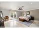 Bright bedroom featuring a ceiling fan, French doors, and a decorative bed covering at 3901 E San Miguel Ave, Paradise Valley, AZ 85253