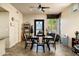 Inviting dining room with decorative tile flooring, ceiling fan, and natural light from the large window and front door at 3901 E San Miguel Ave, Paradise Valley, AZ 85253