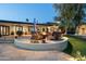 Inviting backyard fire pit area with comfortable seating, lush landscaping, and ambient lighting at 3901 E San Miguel Ave, Paradise Valley, AZ 85253