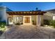 Elegant front entrance featuring a stone courtyard, fountain, and custom wood double doors at 3901 E San Miguel Ave, Paradise Valley, AZ 85253