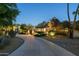 Stunning home exterior featuring a long driveway and beautiful landscape at twilight at 3901 E San Miguel Ave, Paradise Valley, AZ 85253
