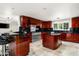 Gourmet kitchen featuring custom wood cabinets, granite countertops, and stainless steel appliances at 3901 E San Miguel Ave, Paradise Valley, AZ 85253