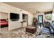 Open-concept living area with TV, a breakfast bar, and cozy seating arrangements at 3901 E San Miguel Ave, Paradise Valley, AZ 85253