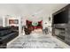 Spacious living room with fireplace, plush seating, and an open layout into the gourmet kitchen at 3901 E San Miguel Ave, Paradise Valley, AZ 85253