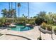 Relaxing backyard pool surrounded by stone patio, umbrellas, and verdant landscaping at 3901 E San Miguel Ave, Paradise Valley, AZ 85253