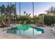 Stunning pool and patio area with stone pavers, lounge chairs, and mature landscaping for privacy at 3901 E San Miguel Ave, Paradise Valley, AZ 85253