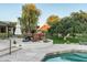 Outdoor lounge area with a full outdoor kitchen and inviting pool in a lush, green backyard at 3901 E San Miguel Ave, Paradise Valley, AZ 85253
