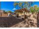 Private backyard featuring a shaded pergola with comfortable seating and a storage shed at 4377 S Soboba St, Gilbert, AZ 85297