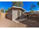 Charming backyard shed with a welcoming exterior, set on a gravel base, and patio in backyard at 4377 S Soboba St, Gilbert, AZ 85297