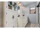 Well-lit bathroom showcasing a dual sink vanity, decorative floors, and plenty of storage at 4377 S Soboba St, Gilbert, AZ 85297