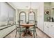 Cozy dining area featuring arched windows, wood floors, and stylish light fixture at 4377 S Soboba St, Gilbert, AZ 85297
