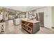 Spacious eat-in kitchen with a center island, stainless steel appliances, and wood flooring at 4377 S Soboba St, Gilbert, AZ 85297