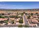 Wide aerial perspective of a residential community nestled under a clear blue sky at 44182 W Juniper Ave, Maricopa, AZ 85138