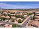 An aerial view showcasing a vibrant residential community under a bright, sunny sky at 44182 W Juniper Ave, Maricopa, AZ 85138