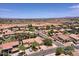 High aerial shot of a sprawling residential area under a clear, sunny sky at 44182 W Juniper Ave, Maricopa, AZ 85138