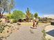 Backyard with gravel landscaping and a fountain at 44182 W Juniper Ave, Maricopa, AZ 85138
