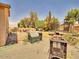 Backyard featuring a fire pit, trampoline, and gravel landscaping at 44182 W Juniper Ave, Maricopa, AZ 85138