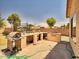 Backyard featuring an outdoor kitchen, grill, and plenty of space for entertaining at 44182 W Juniper Ave, Maricopa, AZ 85138