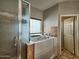 This bathroom features a glass-enclosed shower and a walk-in tub at 44182 W Juniper Ave, Maricopa, AZ 85138
