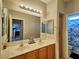 Bathroom featuring a double sink vanity with warm lighting and neutral color tones at 44182 W Juniper Ave, Maricopa, AZ 85138