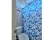 Bathroom featuring a toilet and shower with a blue floral shower curtain at 44182 W Juniper Ave, Maricopa, AZ 85138