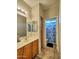 Cozy bathroom with a single sink, wooden cabinet and shower-tub combo at 44182 W Juniper Ave, Maricopa, AZ 85138