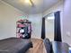 Bright bedroom featuring ceiling fan, workspace, and decorative closet at 44182 W Juniper Ave, Maricopa, AZ 85138