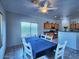 Open dining space with a blue tablecloth and seamless flow into the kitchen at 44182 W Juniper Ave, Maricopa, AZ 85138